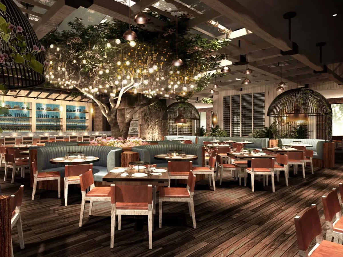 CATCH Las Vegas dining room with a central lit tree, copper pendant lights, teal banquettes, and rust-colored leather chairs