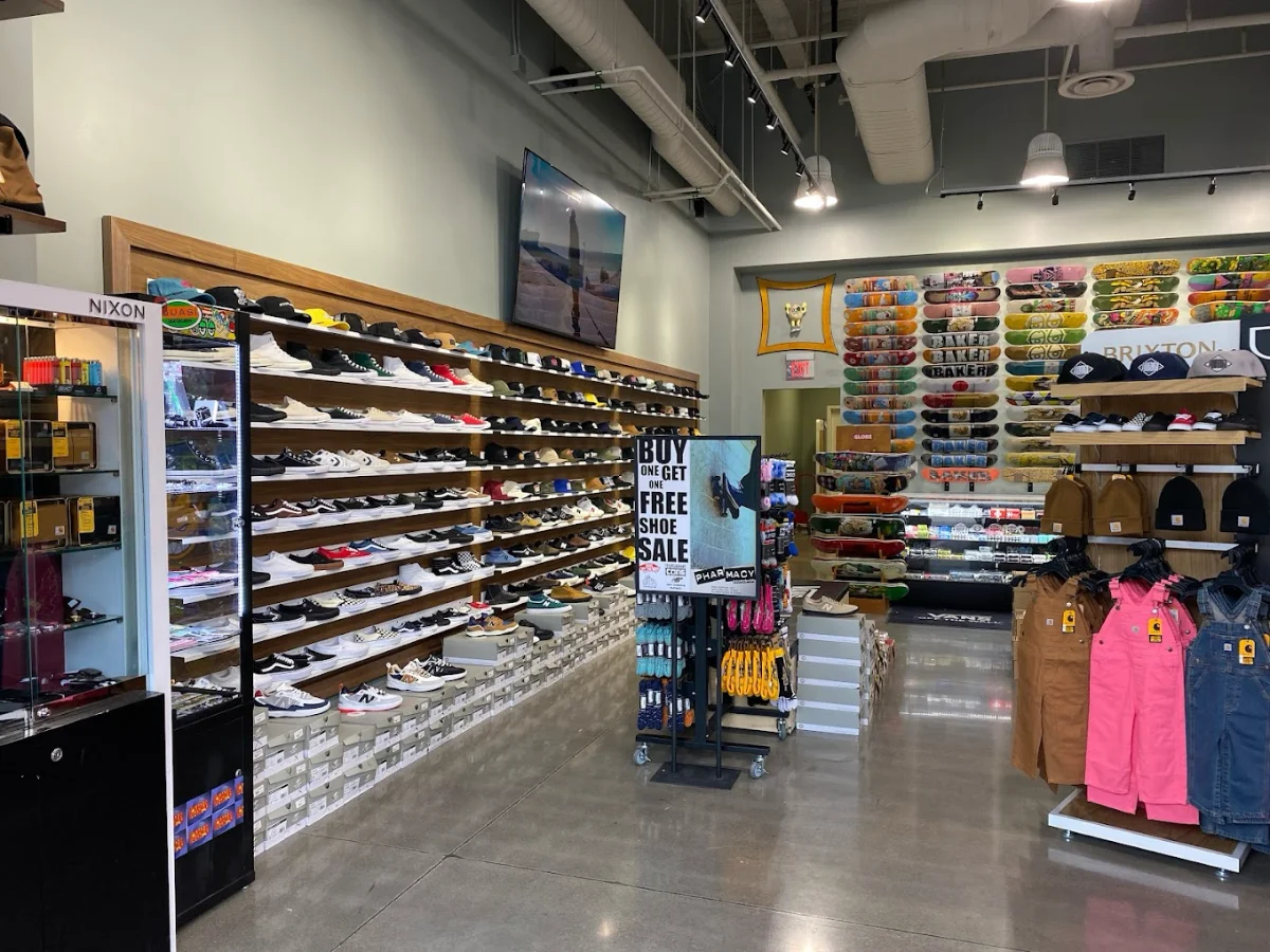 Interior of a Downtown Summerlin store with wall displays of sneakers, shelved apparel, and a sale sign