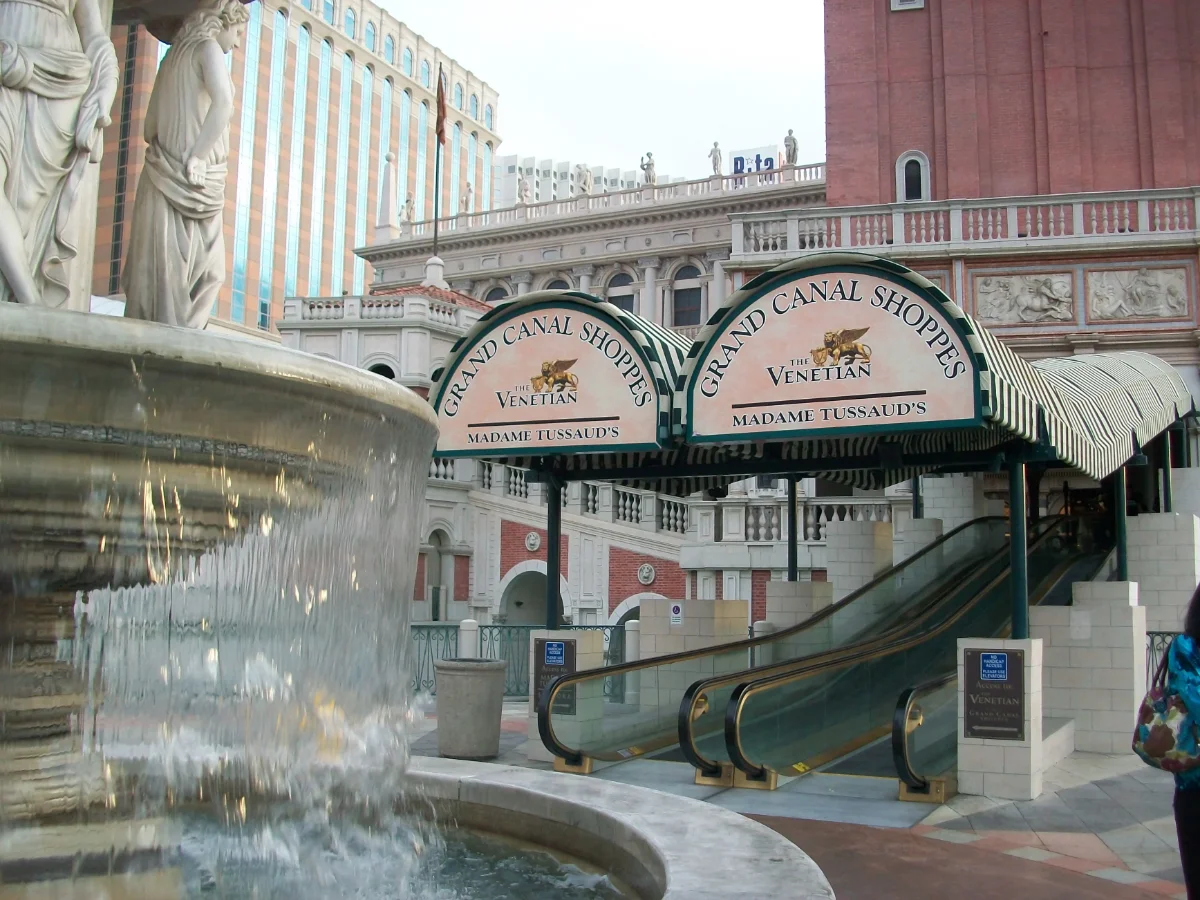 Fountain and statue beside the canopied entrance and escalators of Grand Canal Shoppes at The Venetian