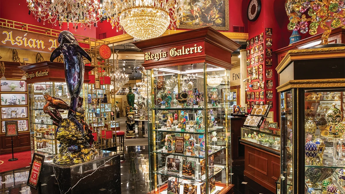 Chandeliers, bronze sculptures, and glass display cases inside the Regis Galerie at Grand Canal Shoppes
