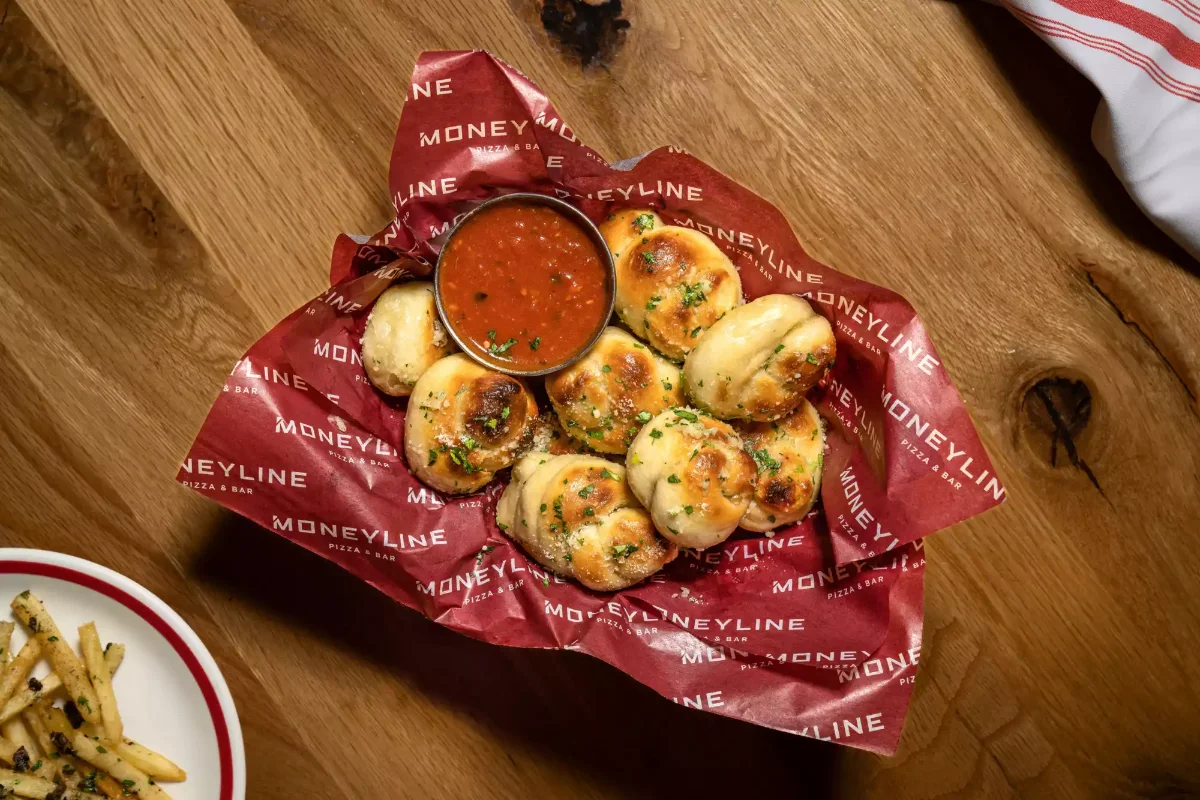 Booth seating and big-screen sports viewing at Moneyline Pizza & Bar