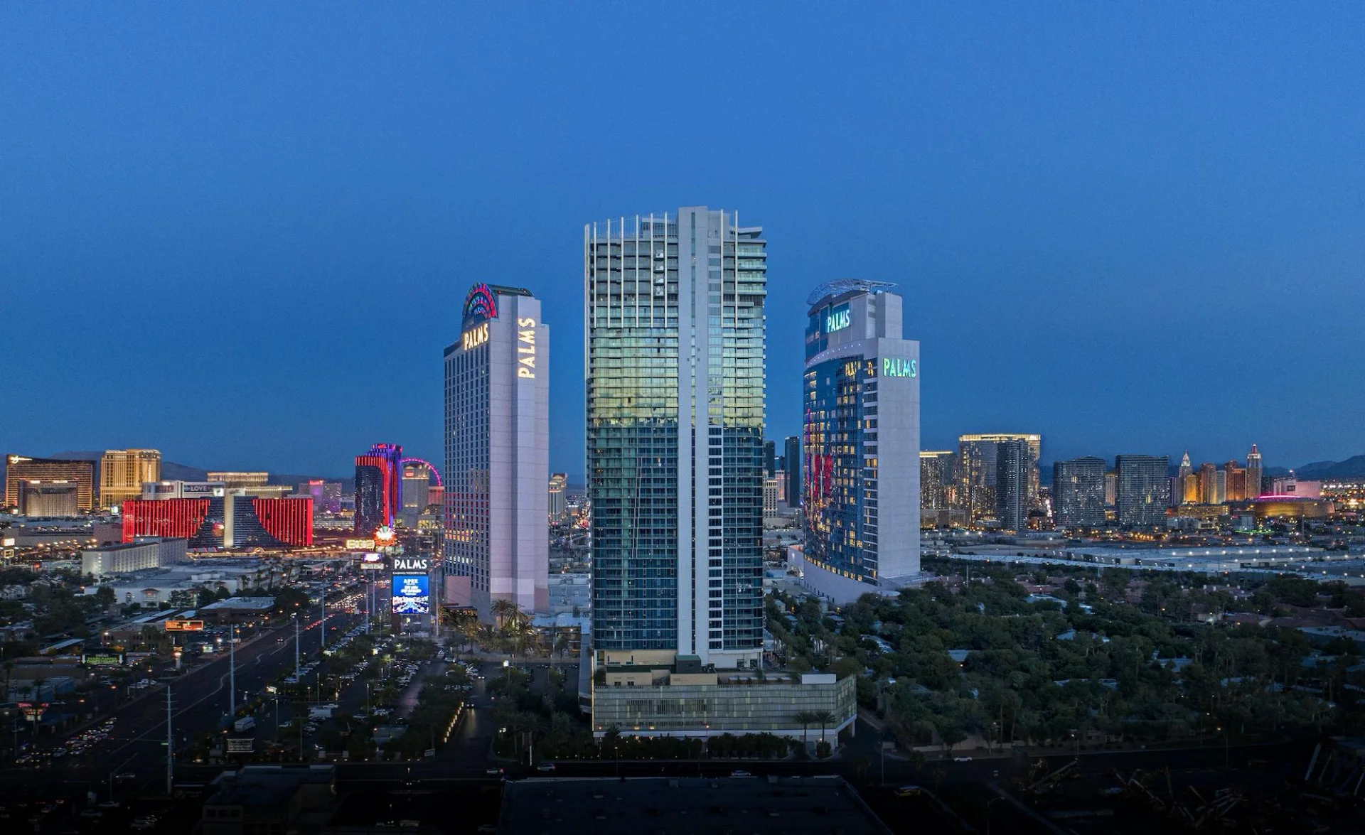 Palms Casino Resort towers at dusk with the Las Vegas skyline