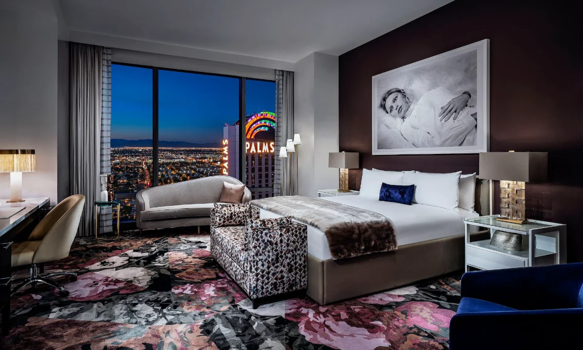 Guest room with king bed and a window view of the Palms marquee