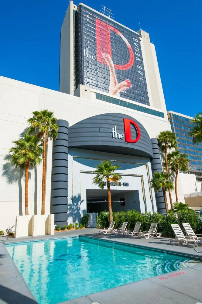 Outdoor pool below The D tower with palm trees
