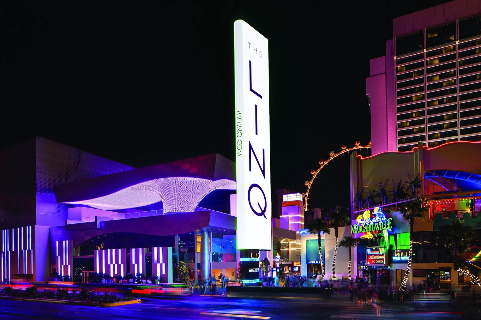 The LINQ illuminated tower sign at night beside the High Roller