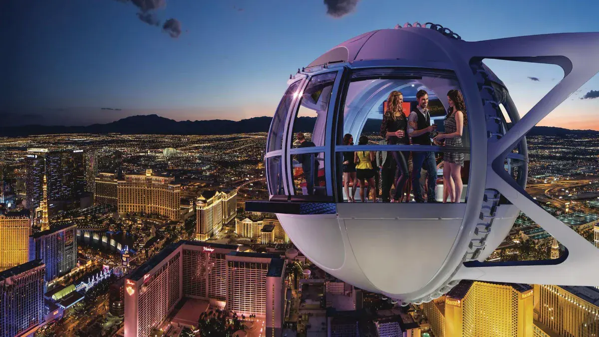 Guests inside a High Roller cabin overlooking the Strip skyline