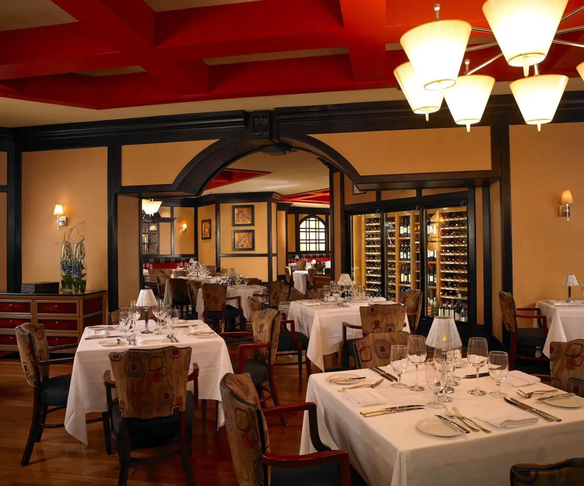 Fine-dining restaurant with red ceiling and wine wall at Treasure Island