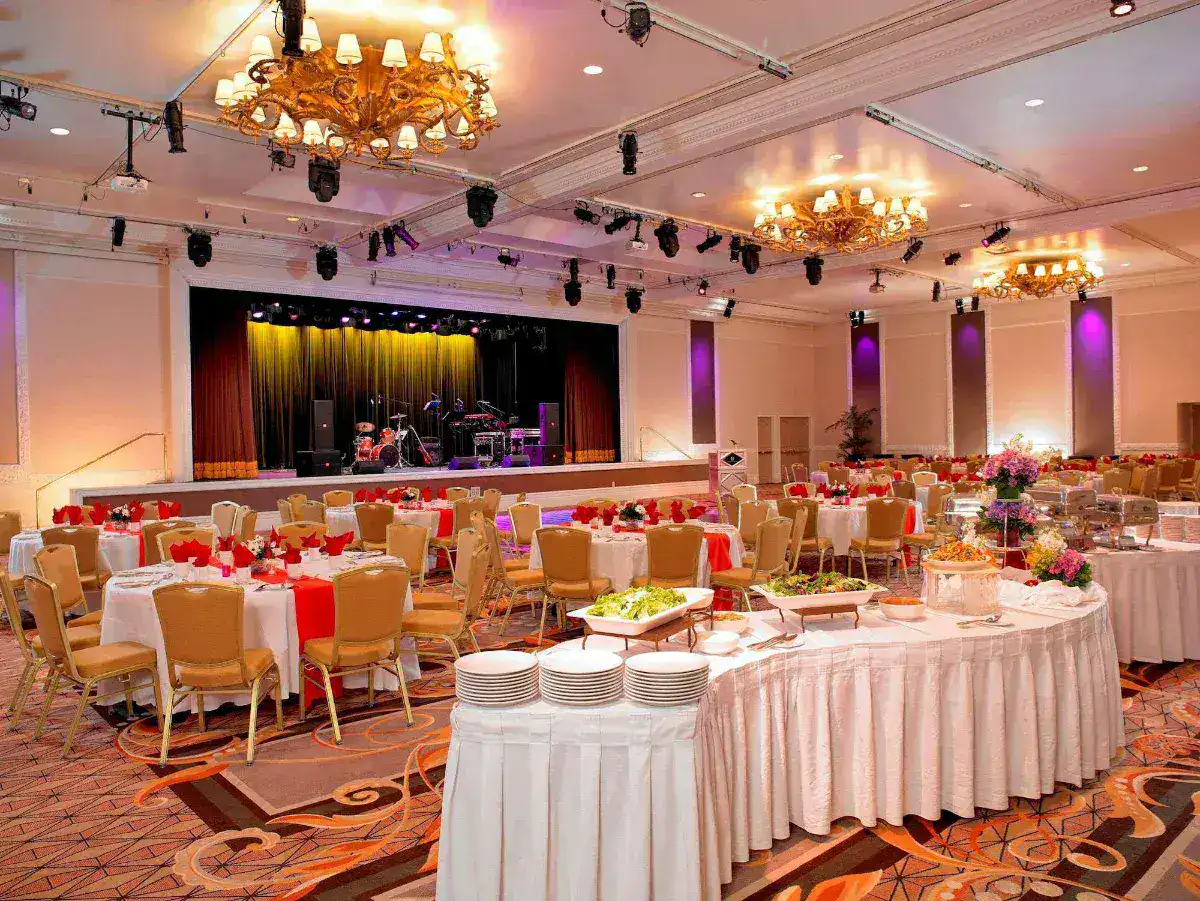 Banquet ballroom set with round tables and a stage at Treasure Island