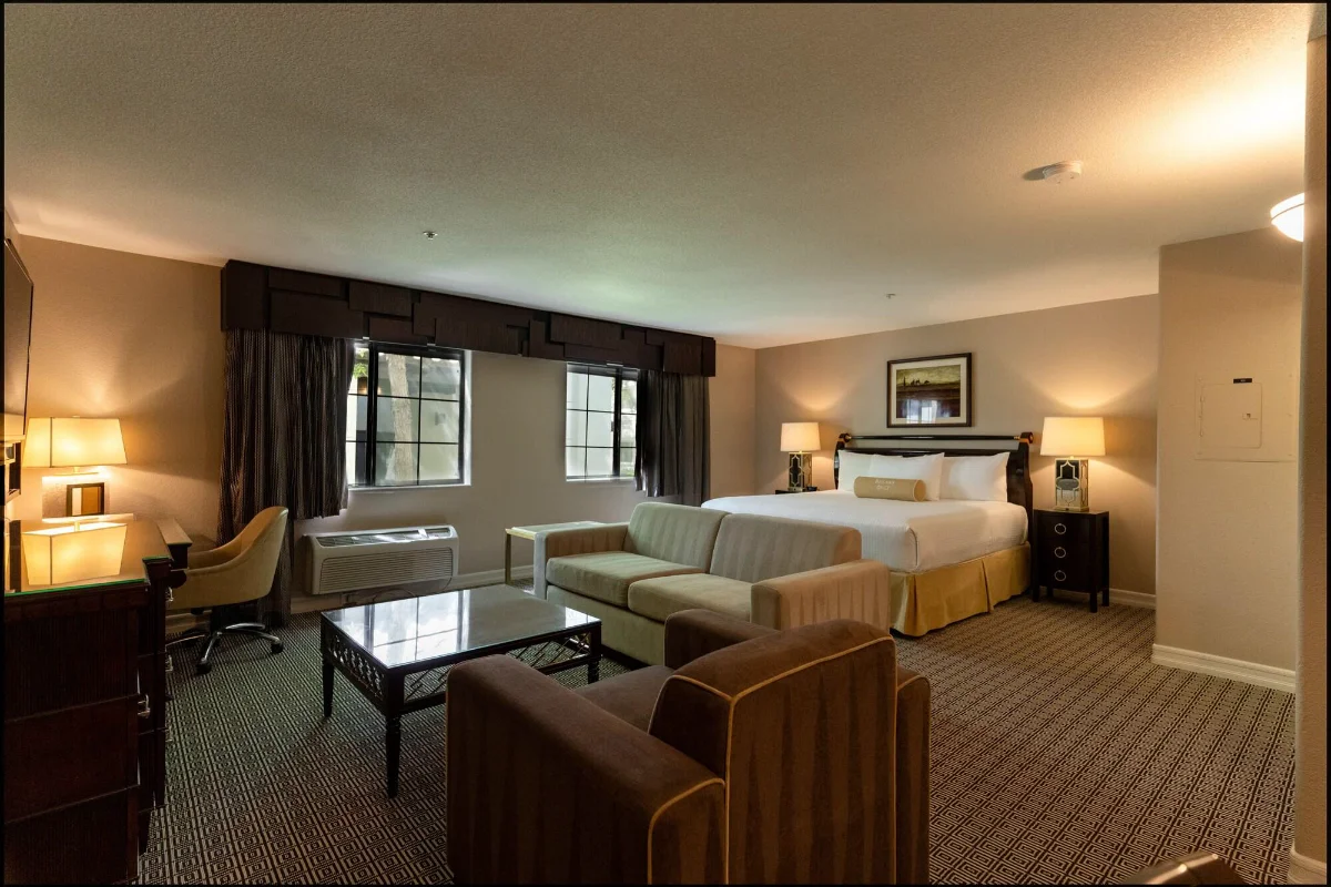 Oversized guest suite with king bed and sitting area at Tuscany