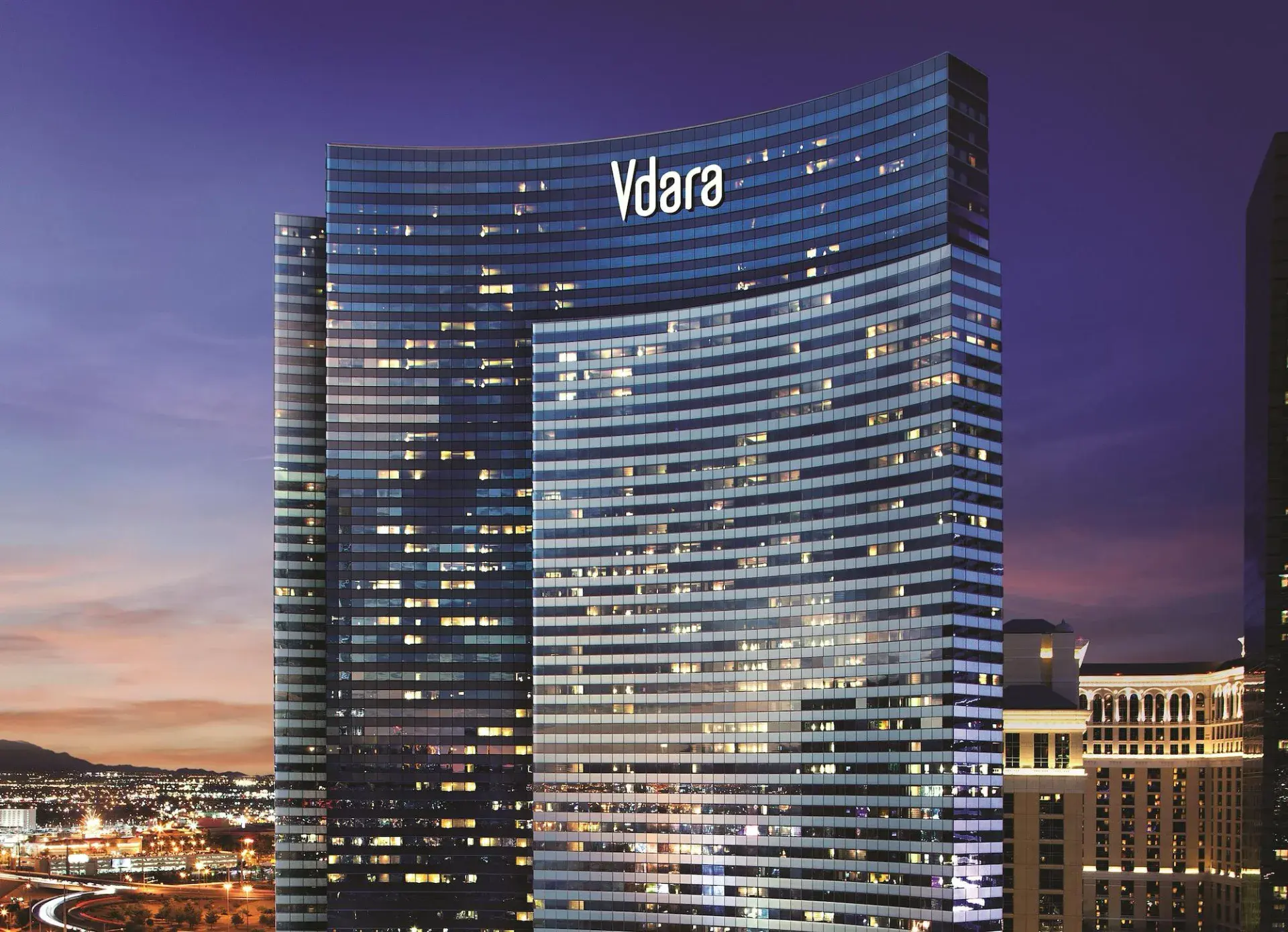 Vdara Hotel & Spa curved glass tower at twilight in Las Vegas