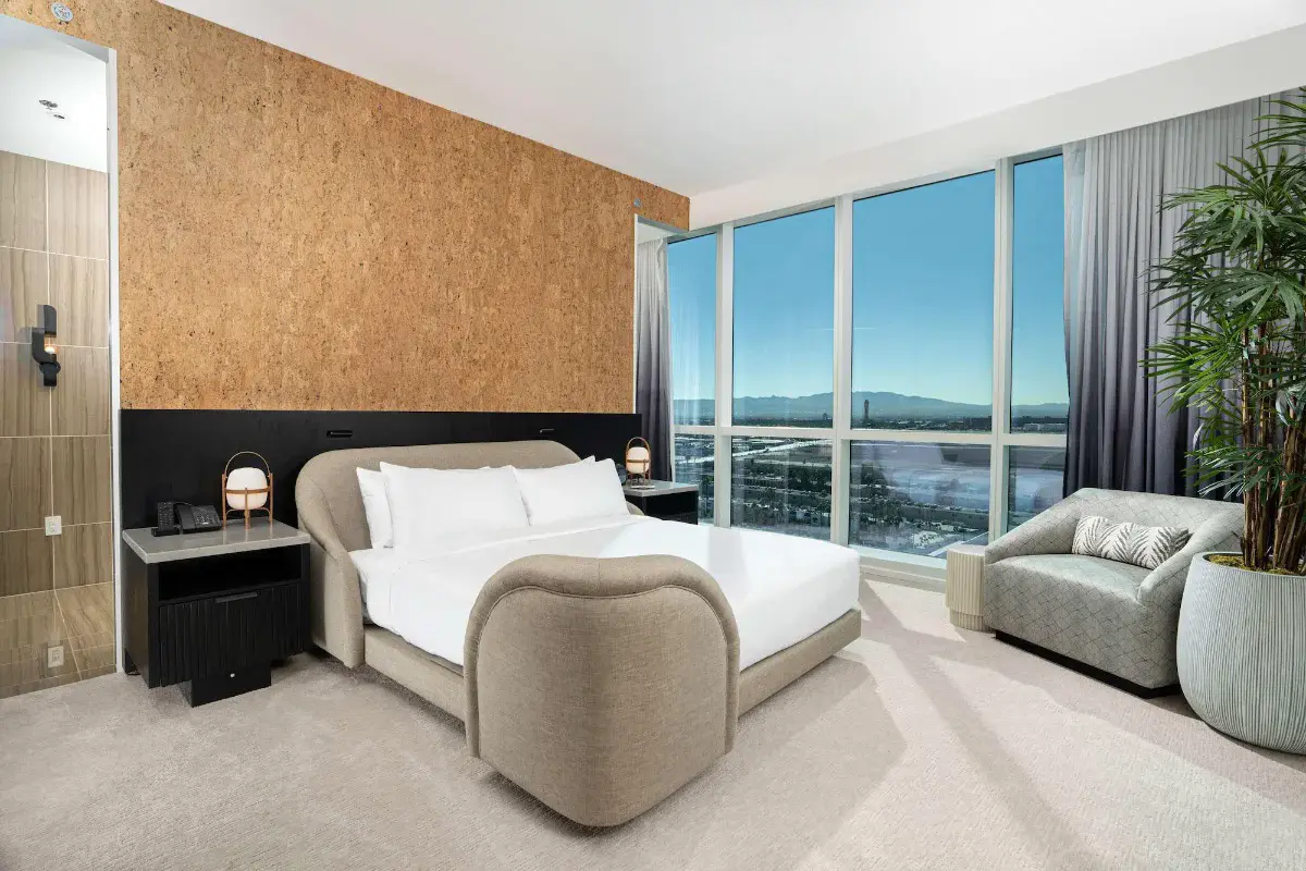 Guest room with cork accent wall and valley views at Virgin Hotels