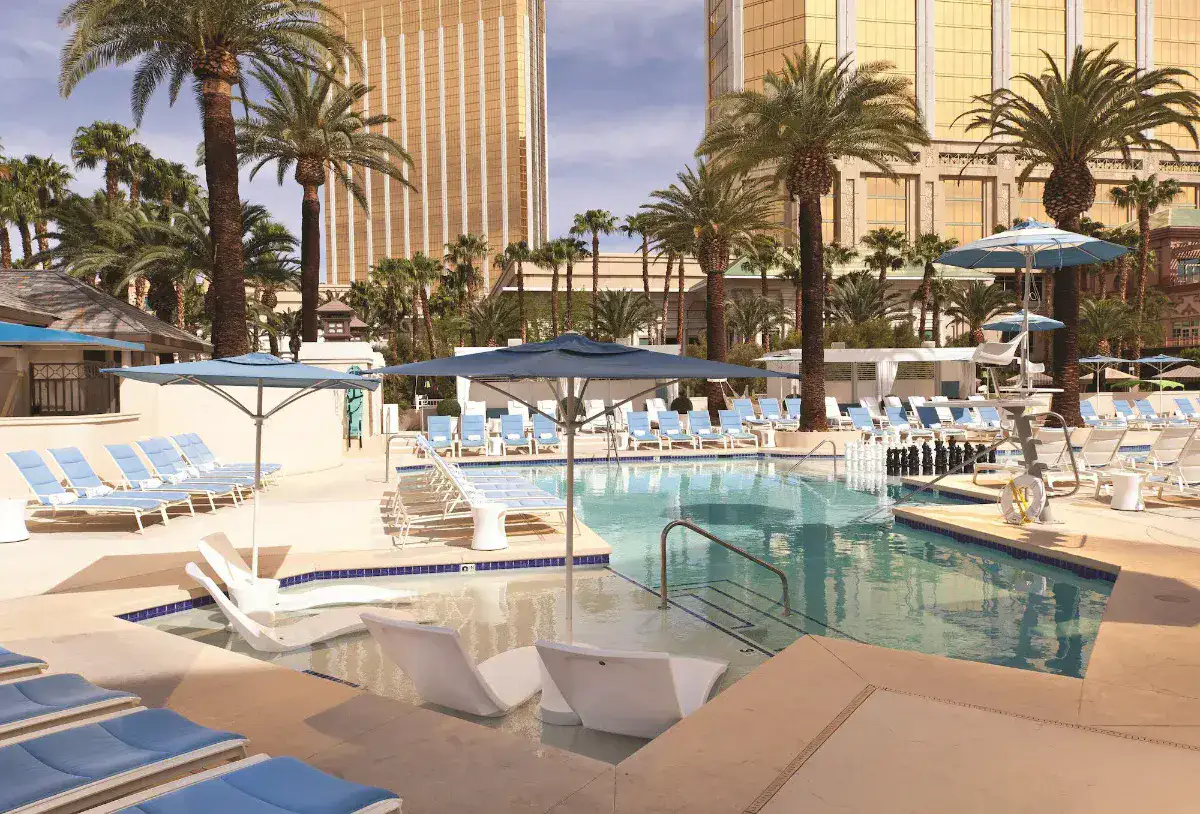 Outdoor pool with cabanas and loungers at W Las Vegas