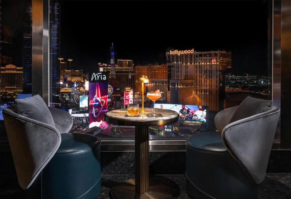 Sky lounge with velvet chairs and a nighttime Strip view at Waldorf Astoria