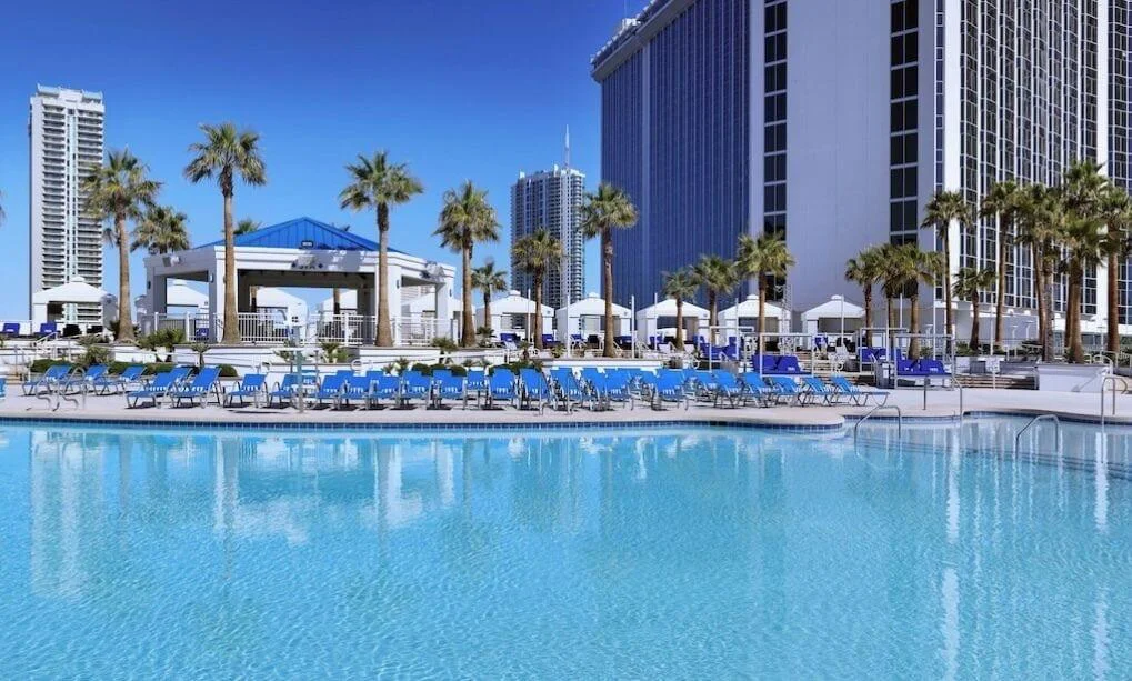 Outdoor pool with loungers and the Westgate tower at Westgate Las Vegas